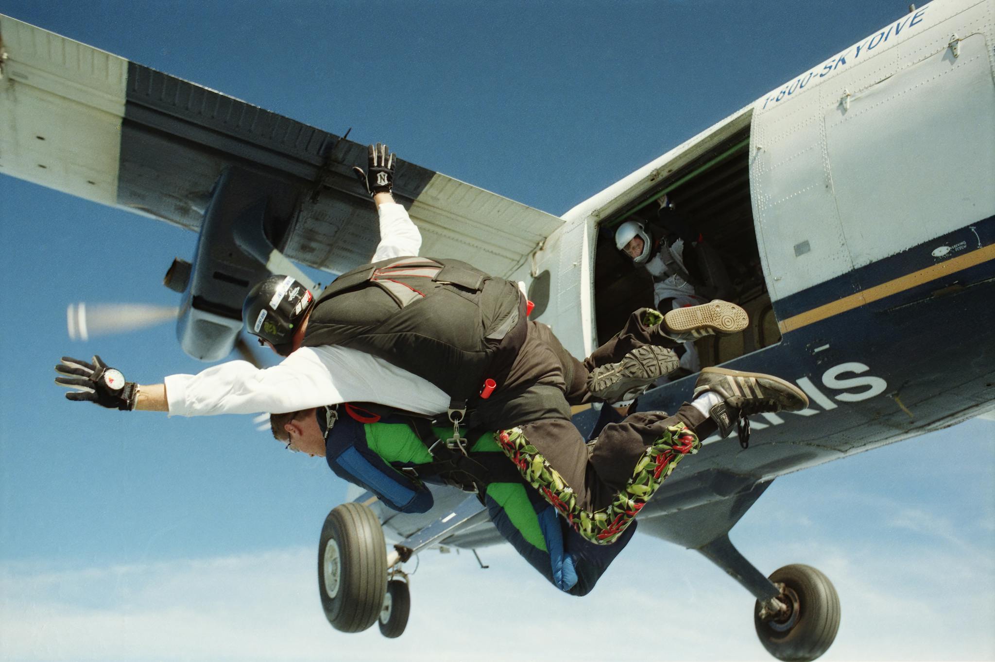 Experience the thrill of tandem skydiving as a pair leaps from an airplane over Wisconsin.